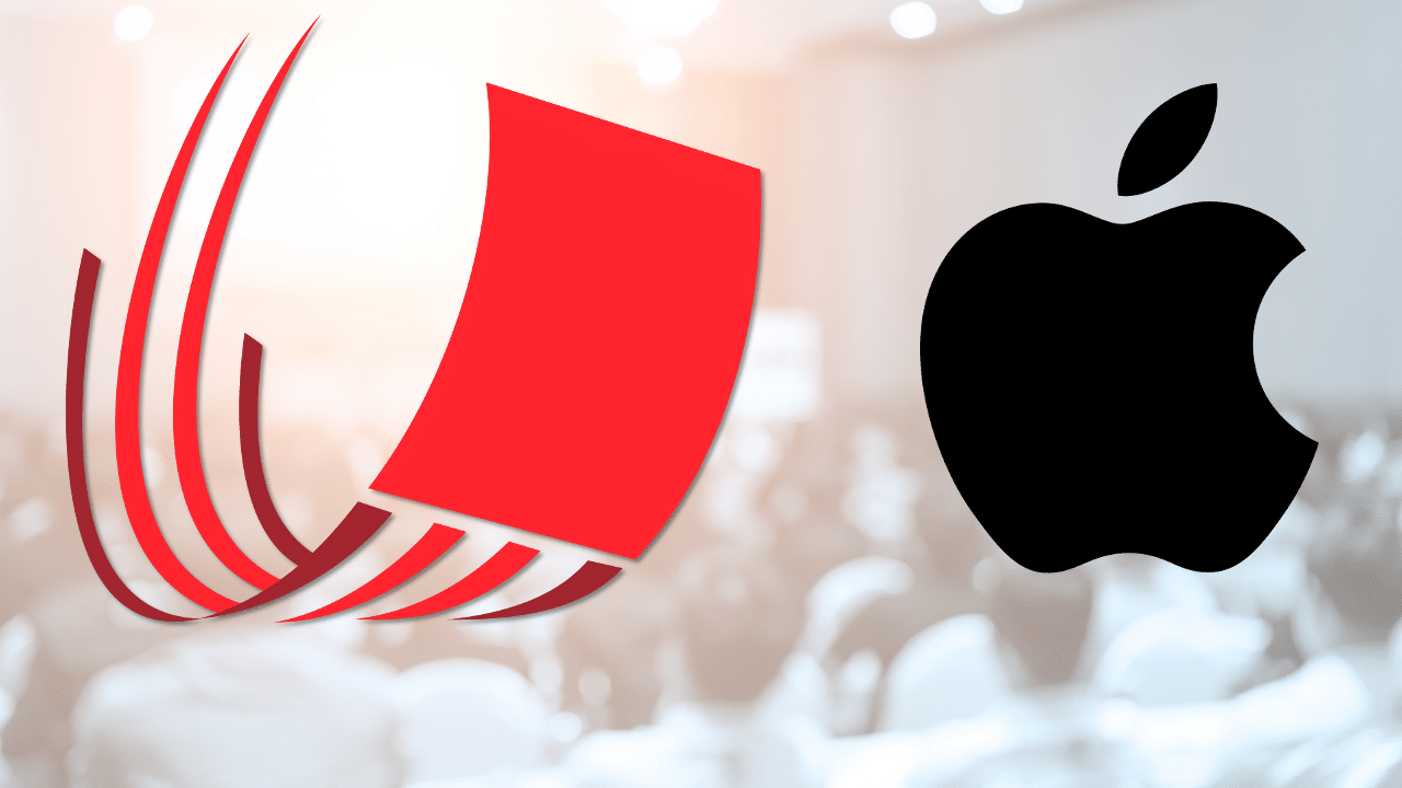 A blurred background of a conference room filled with people, with a red abstract logo on the left and the black Apple logo on the right.