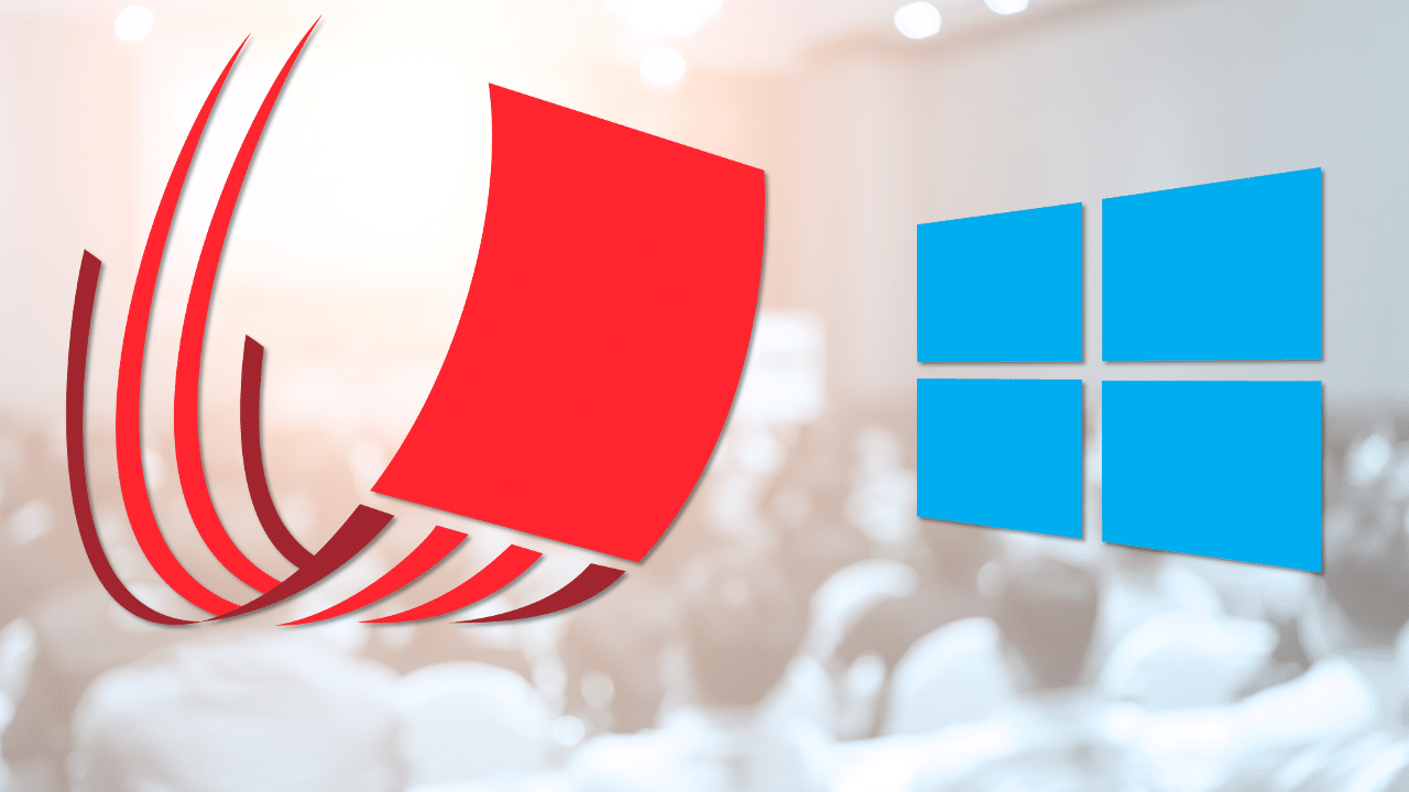 Logos of a technology company and Windows operating system on a blurred background of people seated in an auditorium.